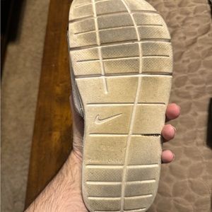 Men’s white Nike flip-flops size 10.